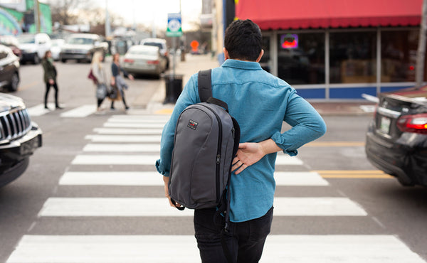 A person slipping their Luminary 15 on at a crosswalk.